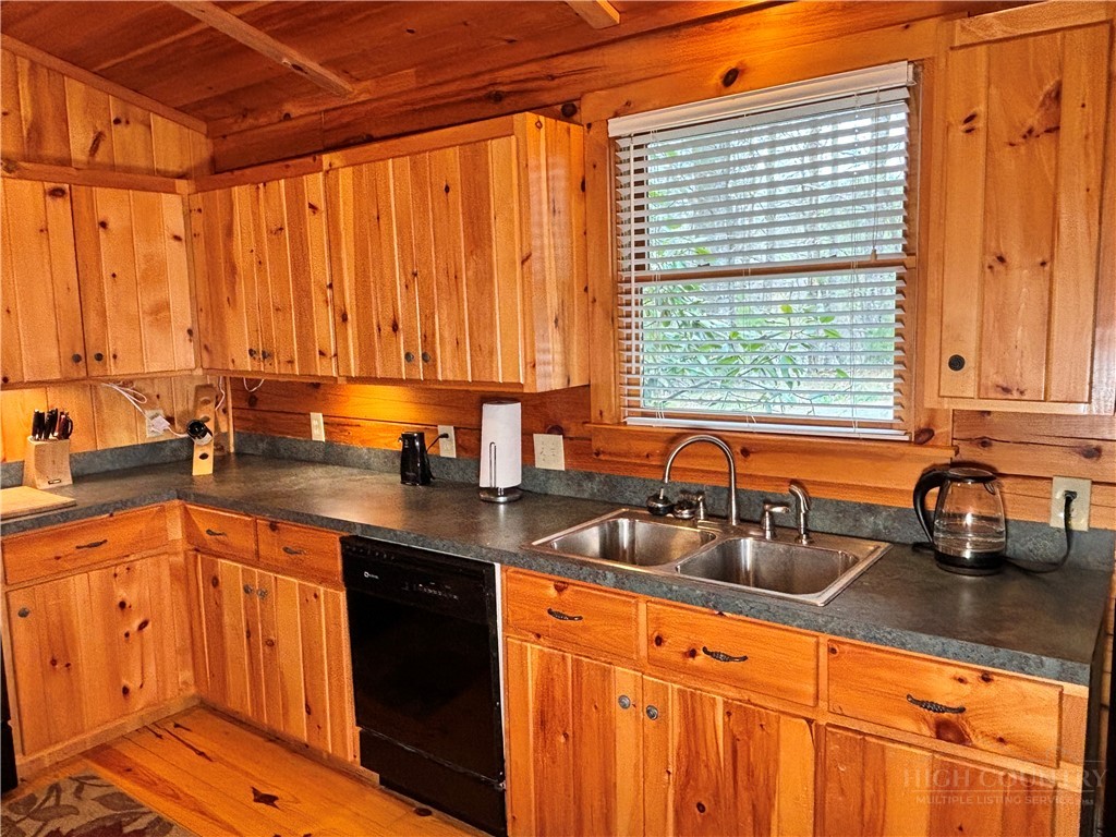 150 Turkey Ridge Crumpler, NC 28617 - Photo 27 of 40 a kitchen with stainless steel appliances a sink dishwasher and cabinets with wooden floor