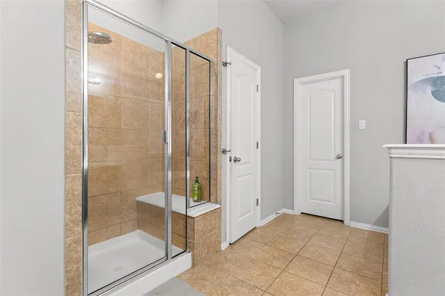 a spacious bathroom with a double vanity sink a mirror and a shower