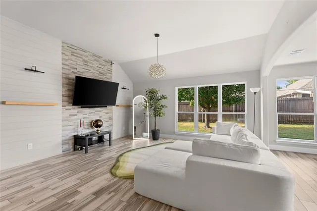 a bedroom with a bed window and flat screen tv