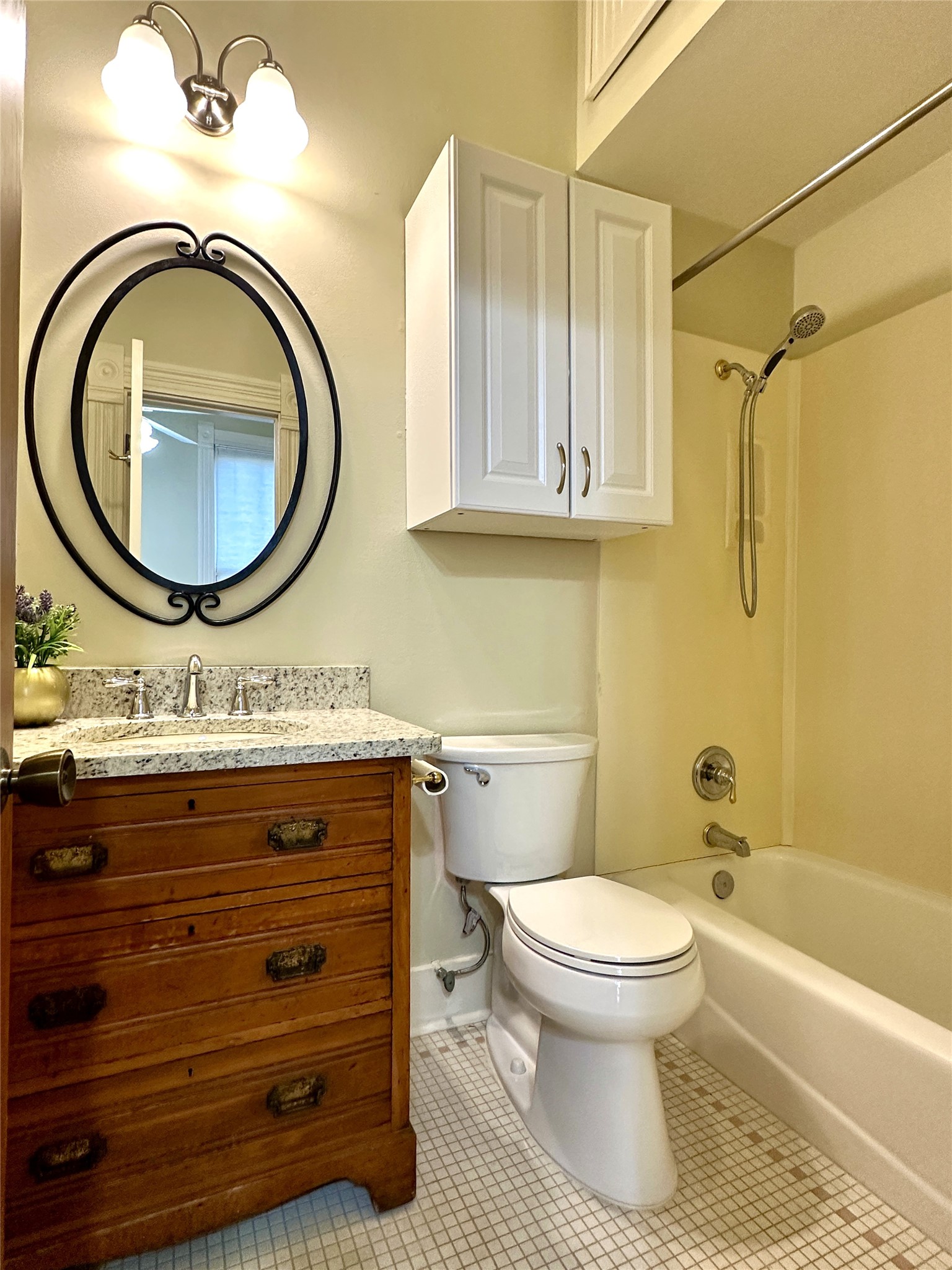 802 Main Street Bastrop, TX 78602 - Photo 14 of 37 a bathroom with a toilet a sink and mirror