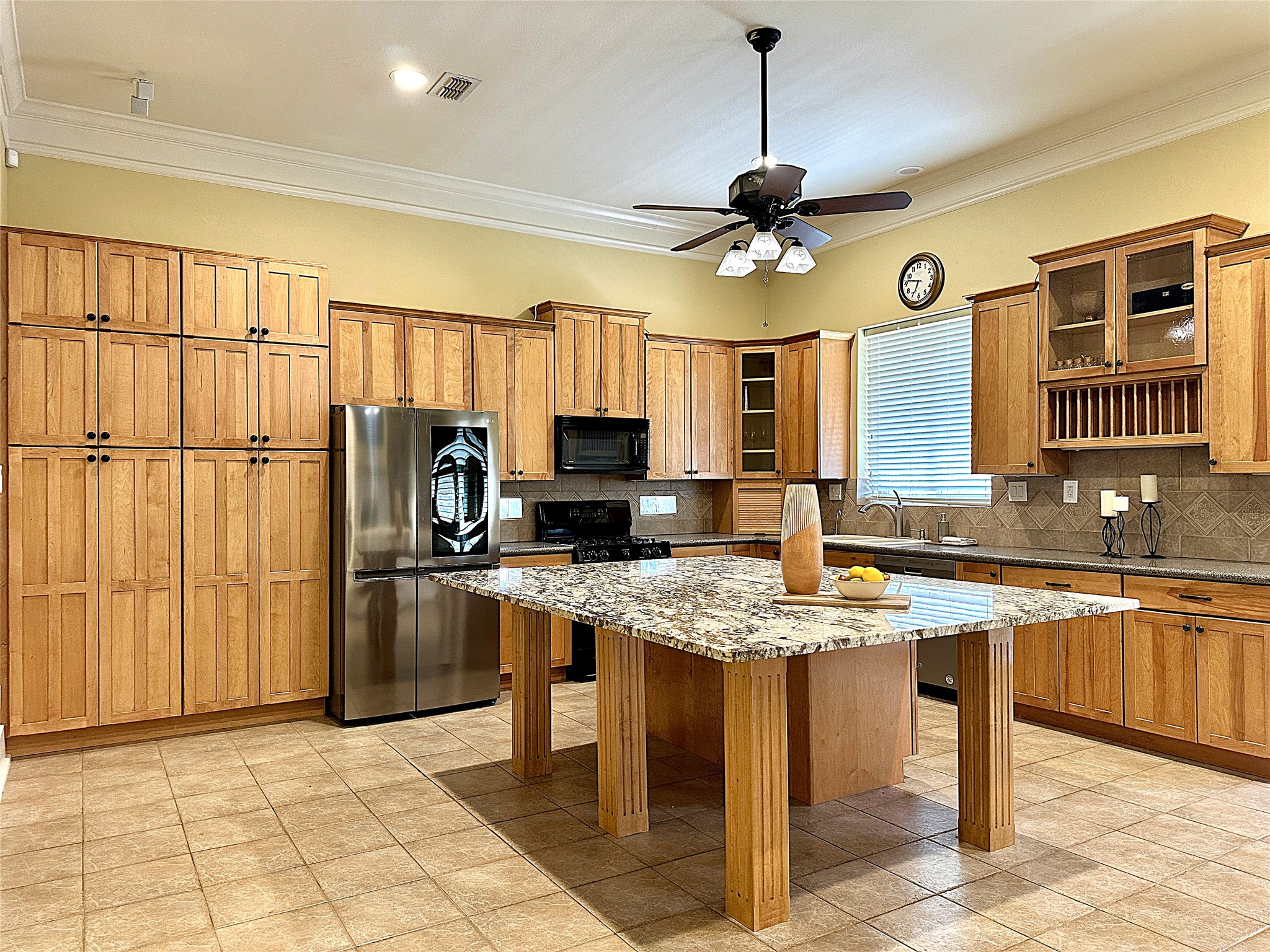 802 Main Street Bastrop, TX 78602 - Photo 18 of 37 a kitchen with stainless steel appliances granite countertop a stove top oven a refrigerator a sink and a granite counter tops
