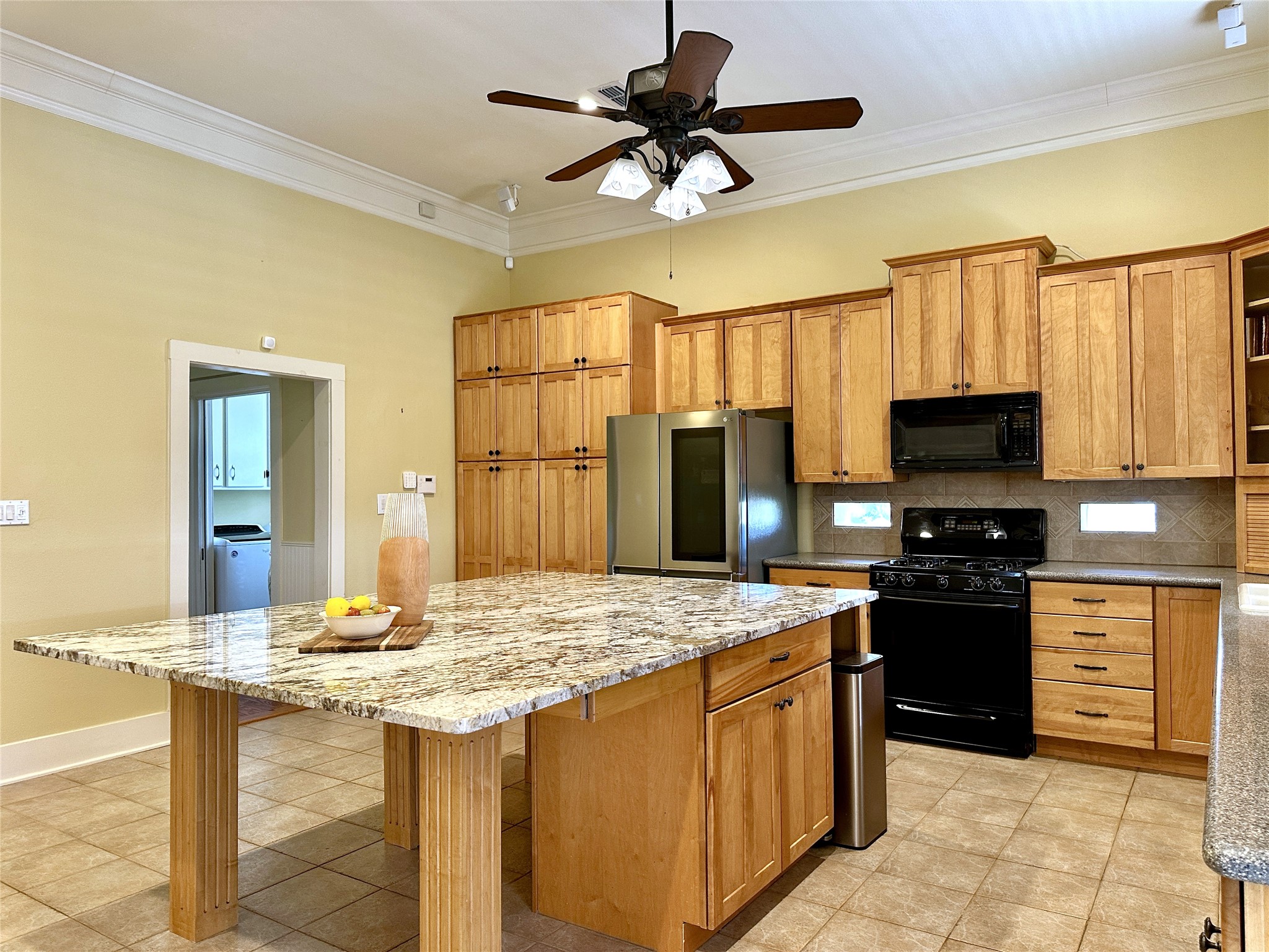 802 Main Street Bastrop, TX 78602 - Photo 19 of 37 a kitchen with a stove a sink and a refrigerator