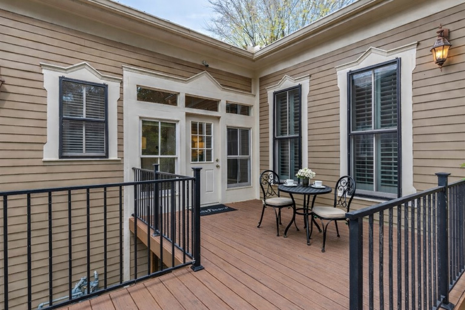 802 Main Street Bastrop, TX 78602 - Photo 27 of 37 a roof deck with table and chairs and wooden floor