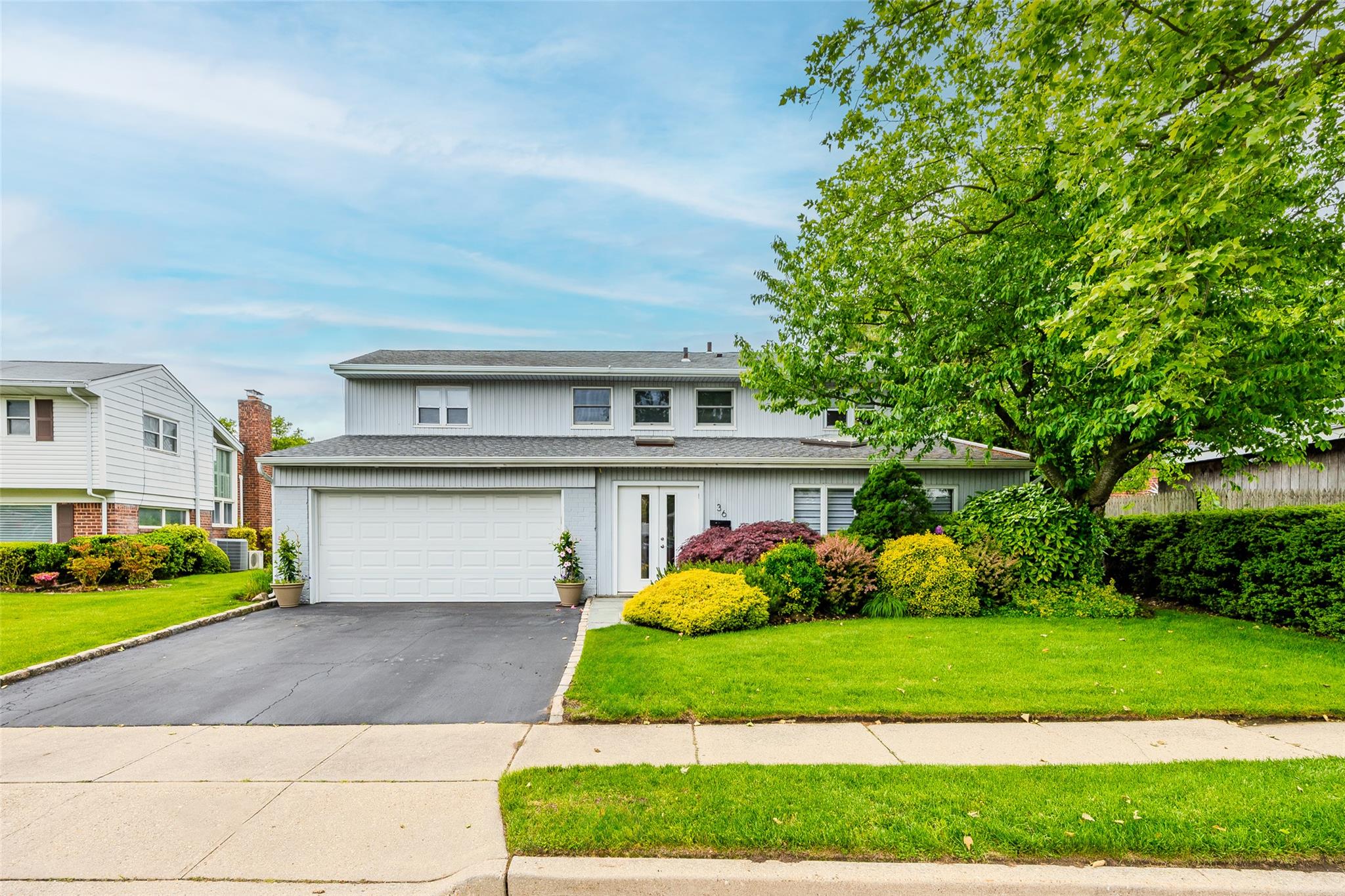36 Randy Lane Plainview, NY 11803 - Photo 1 of 1 a front view of a house with a garden and plants