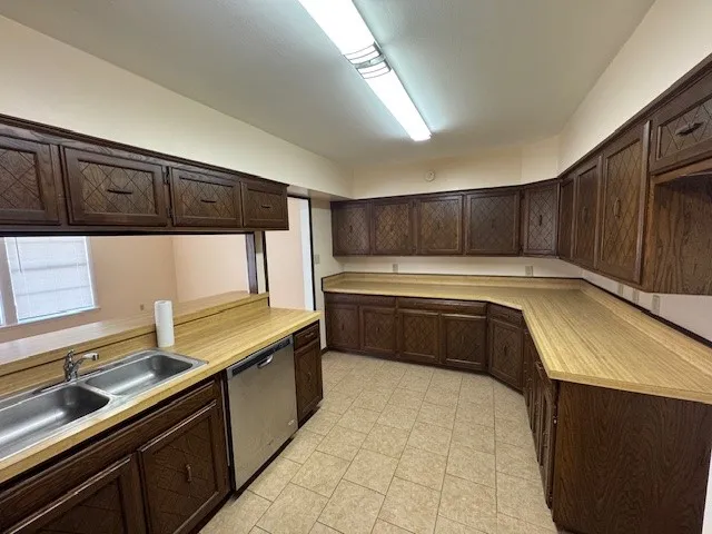 a kitchen with stainless steel appliances a sink stove and cabinets