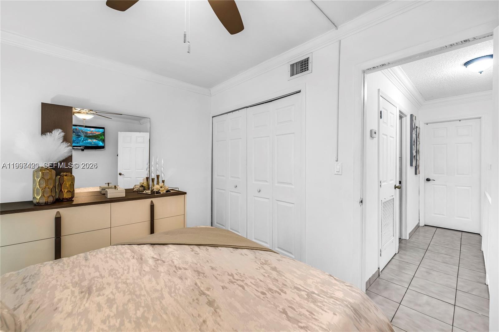 1675 West 57th Street, Unit 514 Hialeah, FL 33012 - Photo 12 of 26 a bedroom with a bed and a dresser