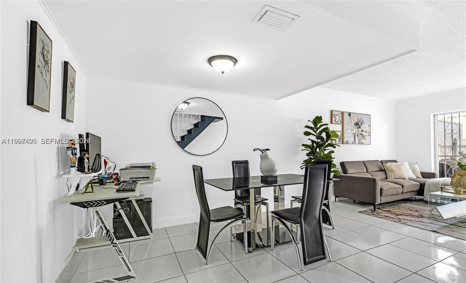 1675 West 57th Street, Unit 514 Hialeah, FL 33012 - Photo 17 of 26 a dining room with furniture and a mirror