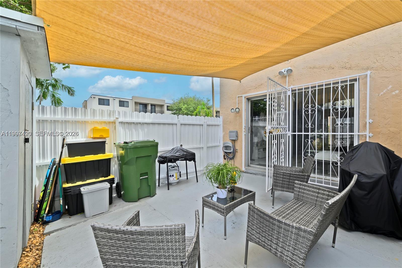 1675 West 57th Street, Unit 514 Hialeah, FL 33012 - Photo 19 of 26 a view of a patio with couches chairs and potted plants