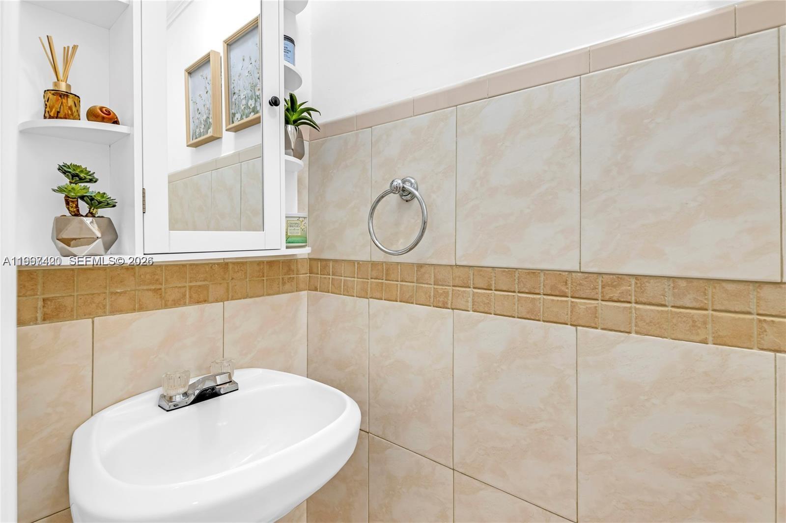 1675 West 57th Street, Unit 514 Hialeah, FL 33012 - Photo 21 of 26 a bathroom with a sink and a mirror