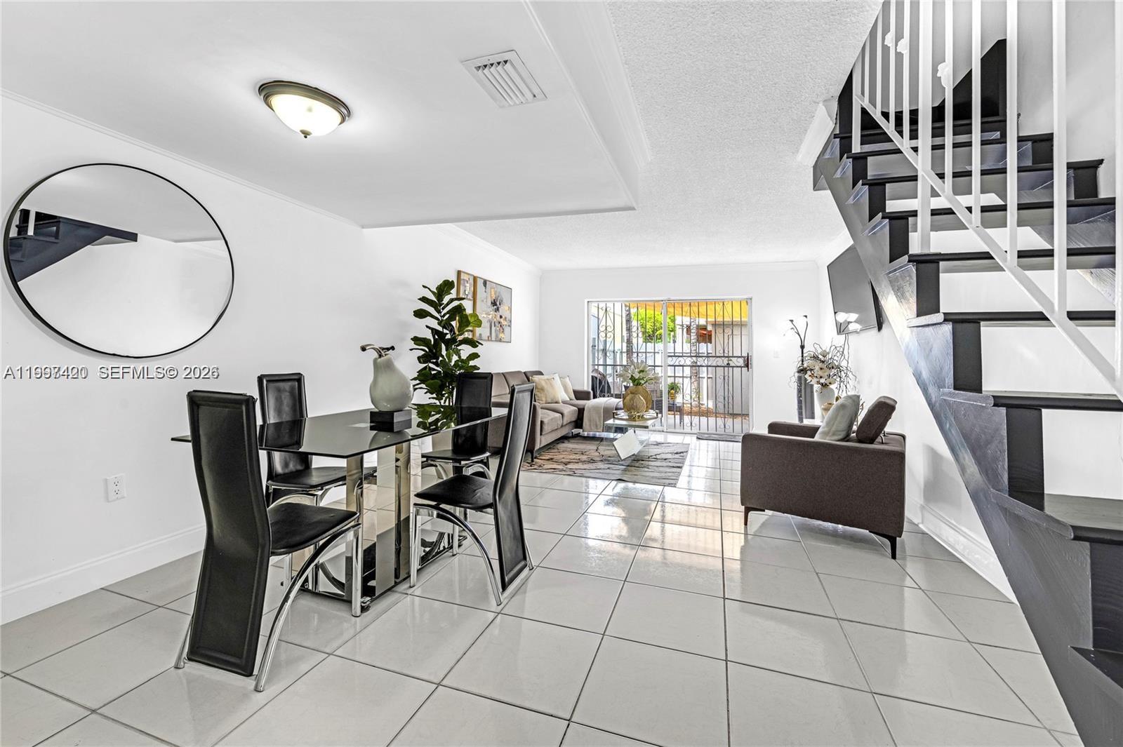 1675 West 57th Street, Unit 514 Hialeah, FL 33012 - Photo 6 of 26 a living room with fireplace furniture and a potted plant