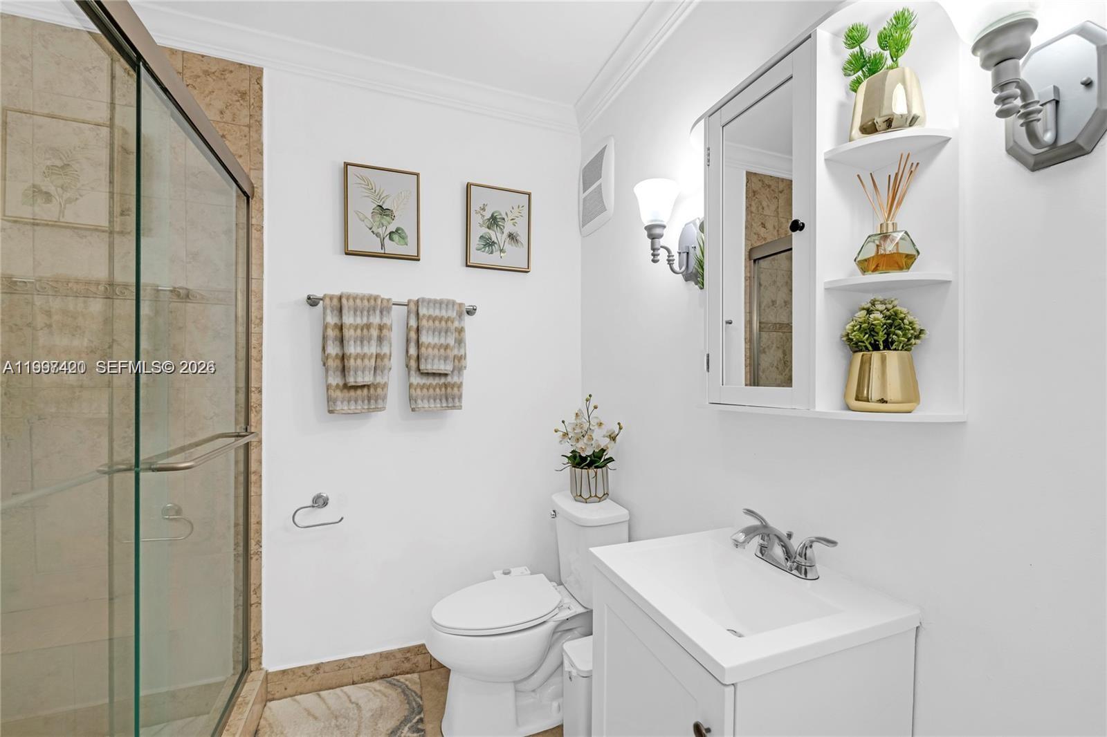 1675 West 57th Street, Unit 514 Hialeah, FL 33012 - Photo 9 of 26 a bathroom with a sink toilet and shower