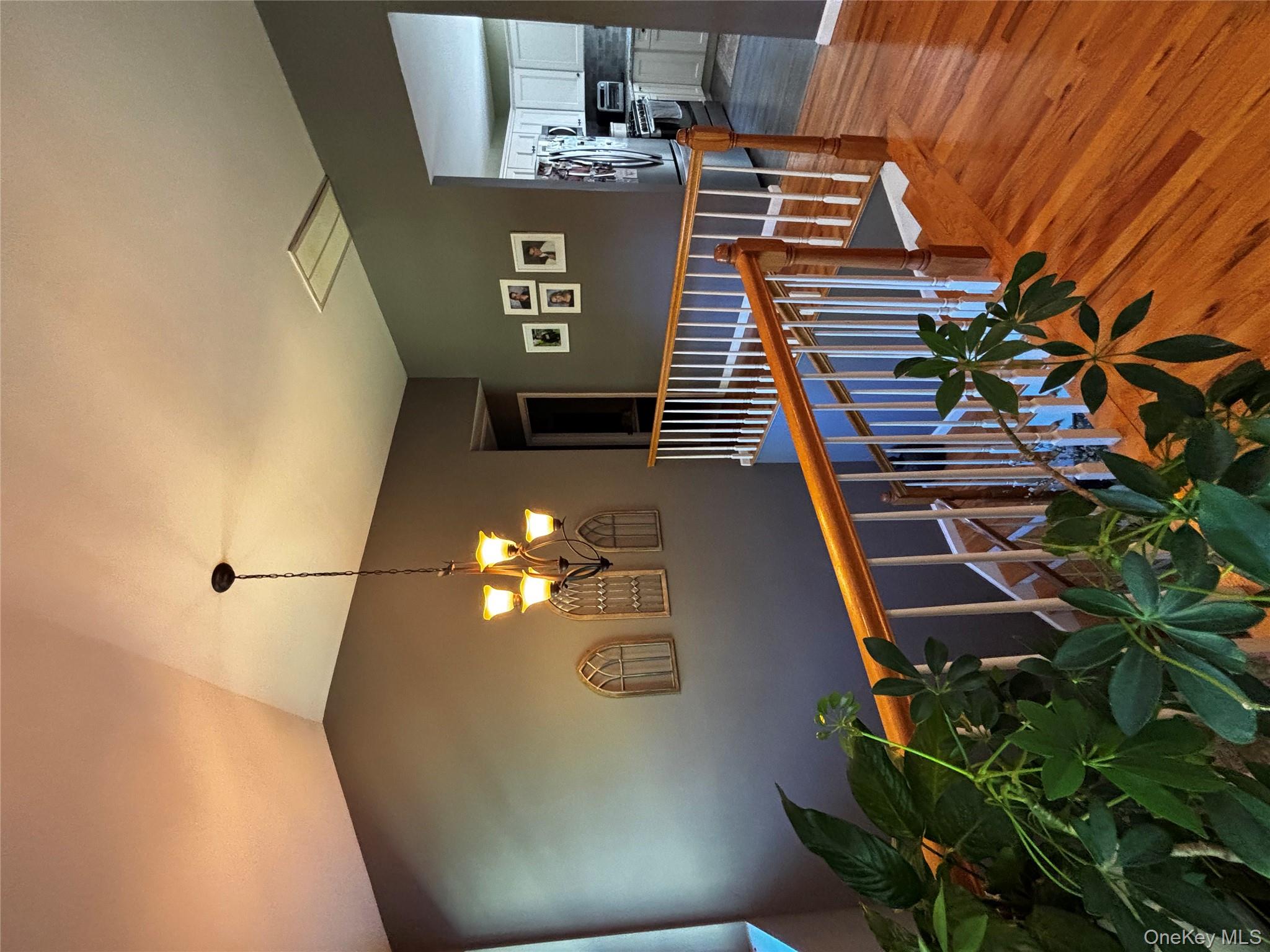 62 Triangle Of Clearwater Road Highland, NY 12528 - Photo 15 of 46 Corridor featuring wood finished floors, an upstairs landing, a chandelier, and lofted ceiling