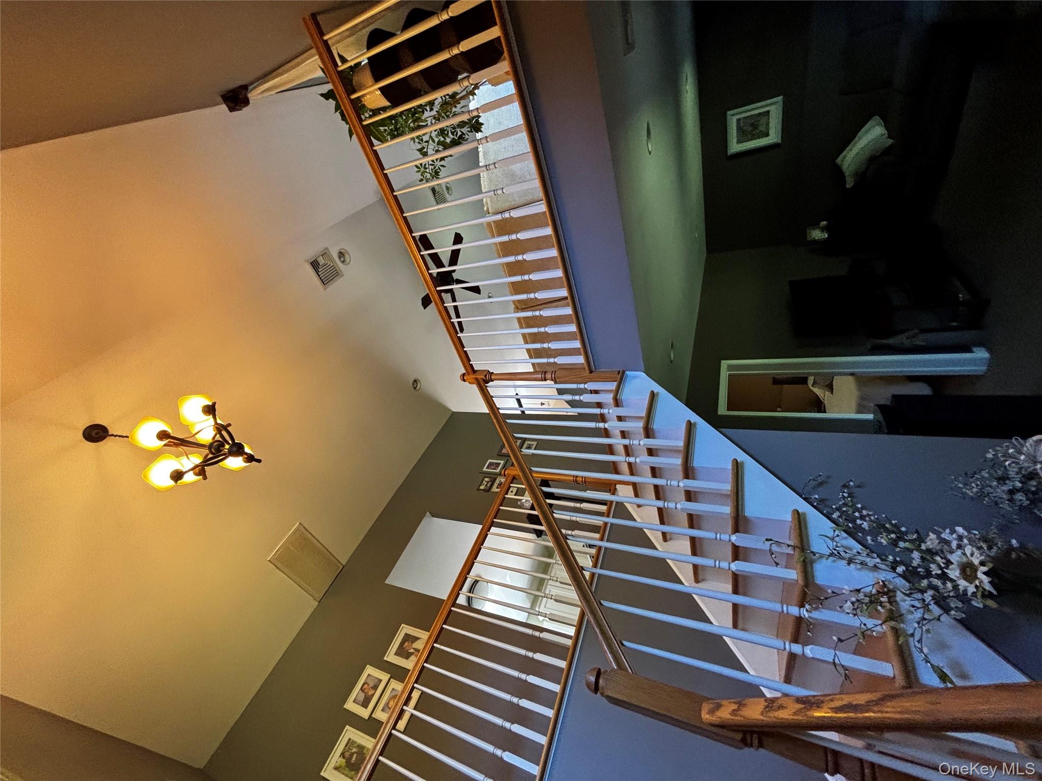 62 Triangle Of Clearwater Road Highland, NY 12528 - Photo 24 of 46 Stairway with a towering ceiling and a chandelier
