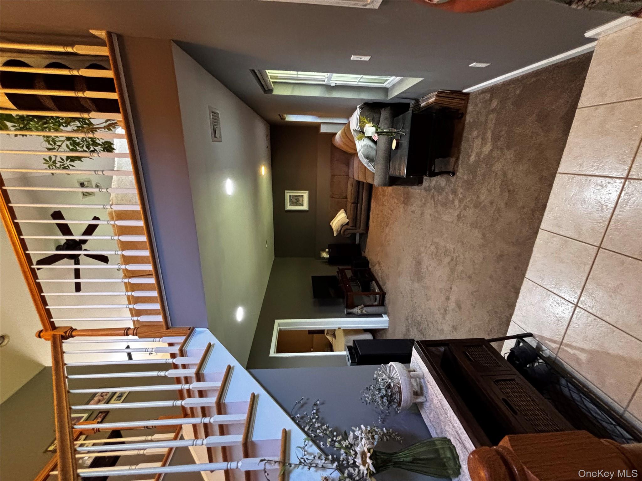 62 Triangle Of Clearwater Road Highland, NY 12528 - Photo 25 of 46 Living area with carpet floors, stairway, tile patterned flooring, and recessed lighting