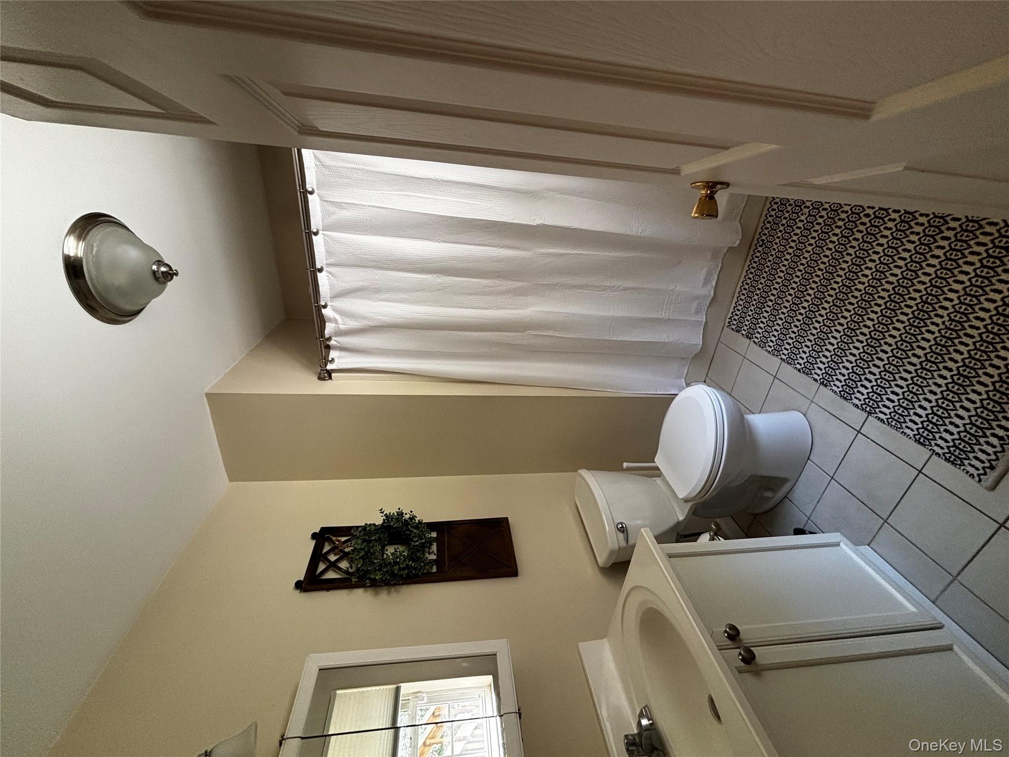62 Triangle Of Clearwater Road Highland, NY 12528 - Photo 28 of 46 Bathroom with vanity, light tile patterned floors, and a shower with shower curtain