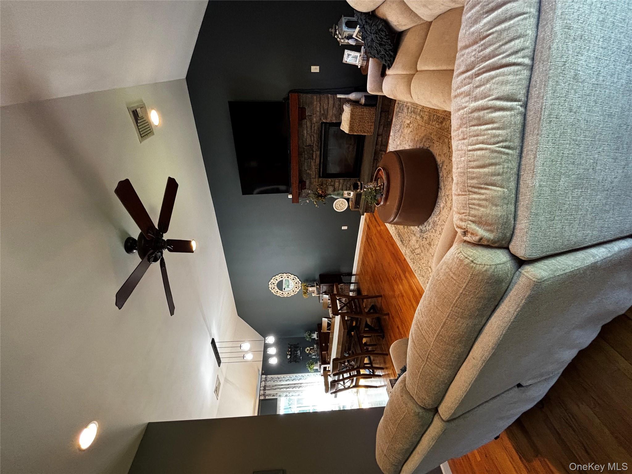 62 Triangle Of Clearwater Road Highland, NY 12528 - Photo 39 of 46 Living room featuring lofted ceiling, wood finished floors, a fireplace, recessed lighting, and ceiling fan