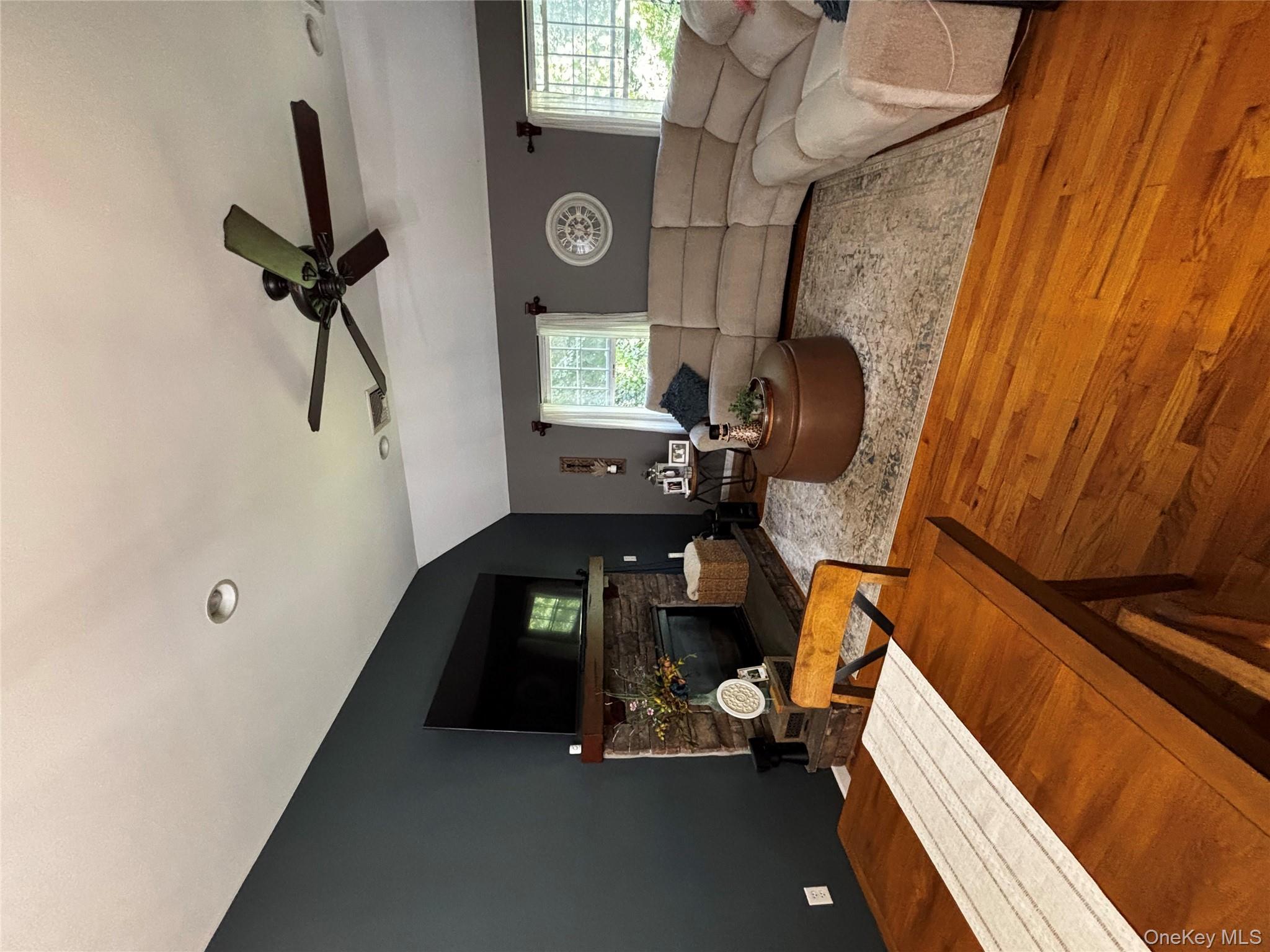 62 Triangle Of Clearwater Road Highland, NY 12528 - Photo 40 of 46 Living area with vaulted ceiling, light wood-type flooring, a stone fireplace, and ceiling fan