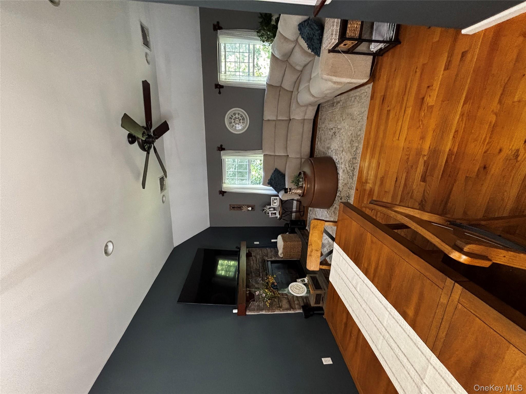 62 Triangle Of Clearwater Road Highland, NY 12528 - Photo 41 of 46 Dining room with vaulted ceiling, light wood-style floors, a stone fireplace, and ceiling fan