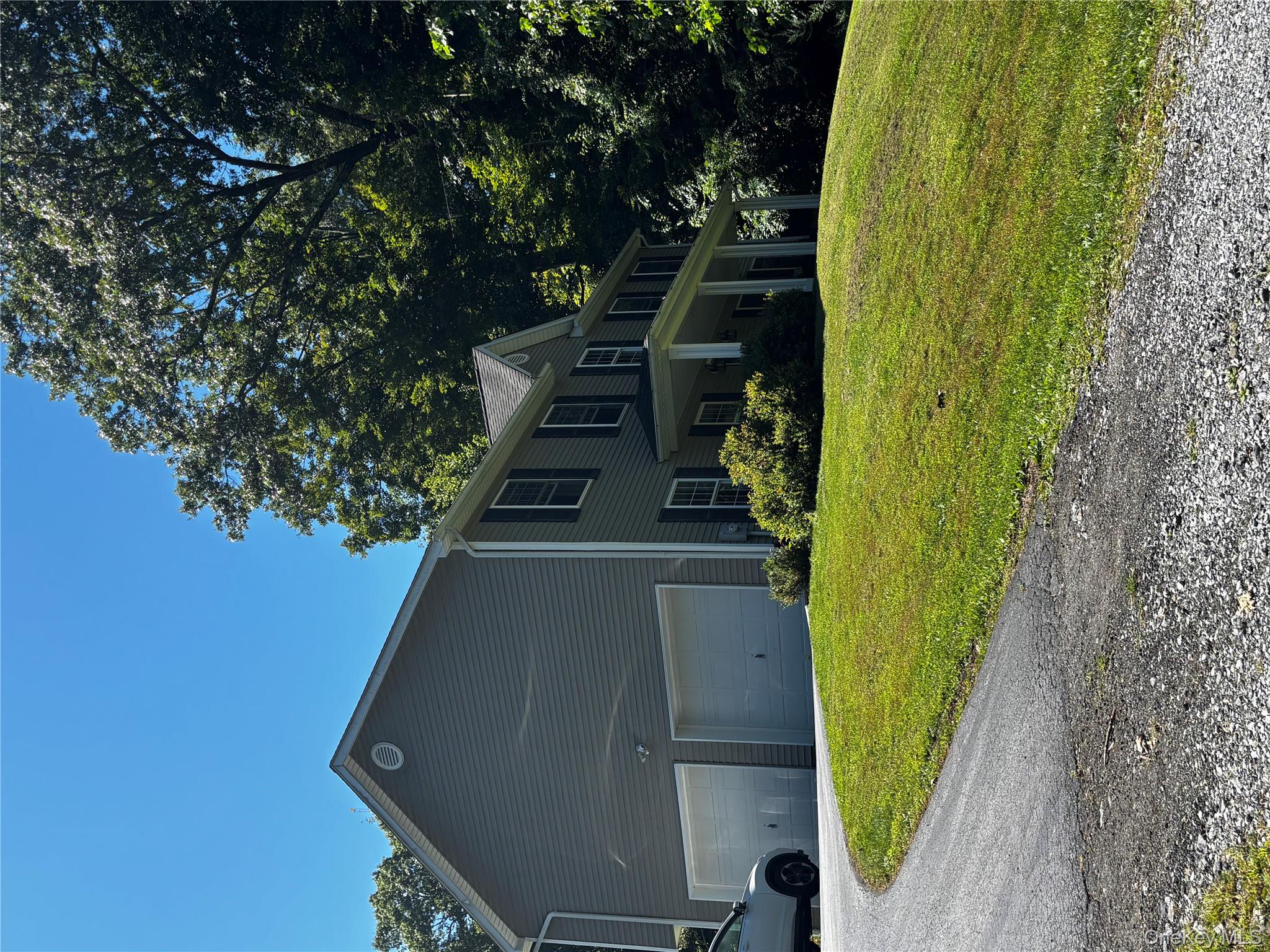 62 Triangle Of Clearwater Road Highland, NY 12528 - Photo 43 of 46 View of home's exterior with a garage, driveway, a yard, and covered porch