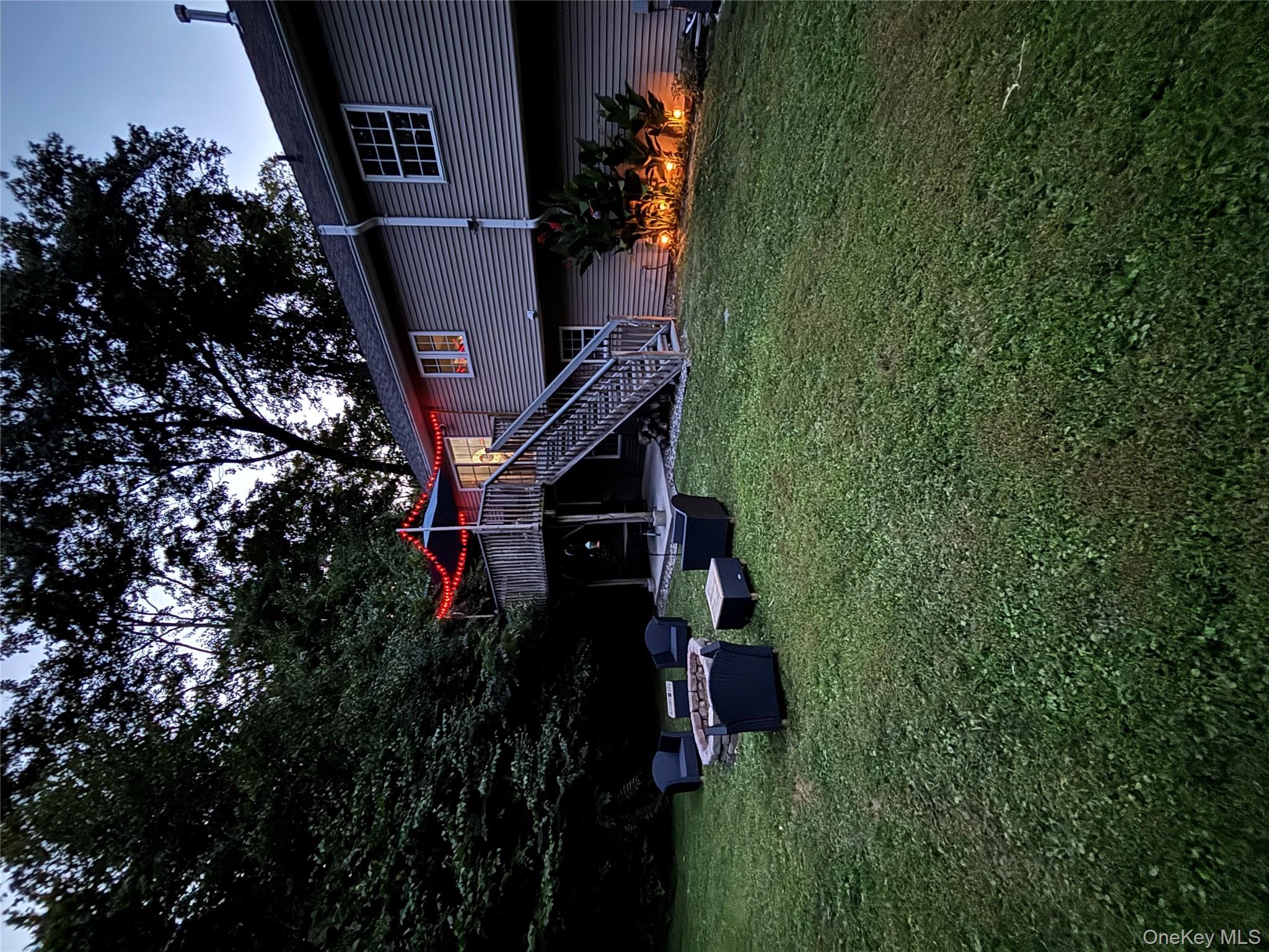 62 Triangle Of Clearwater Road Highland, NY 12528 - Photo 45 of 46 Rear view of property with stairway, a deck, a lawn, and an outdoor living space with a fire pit