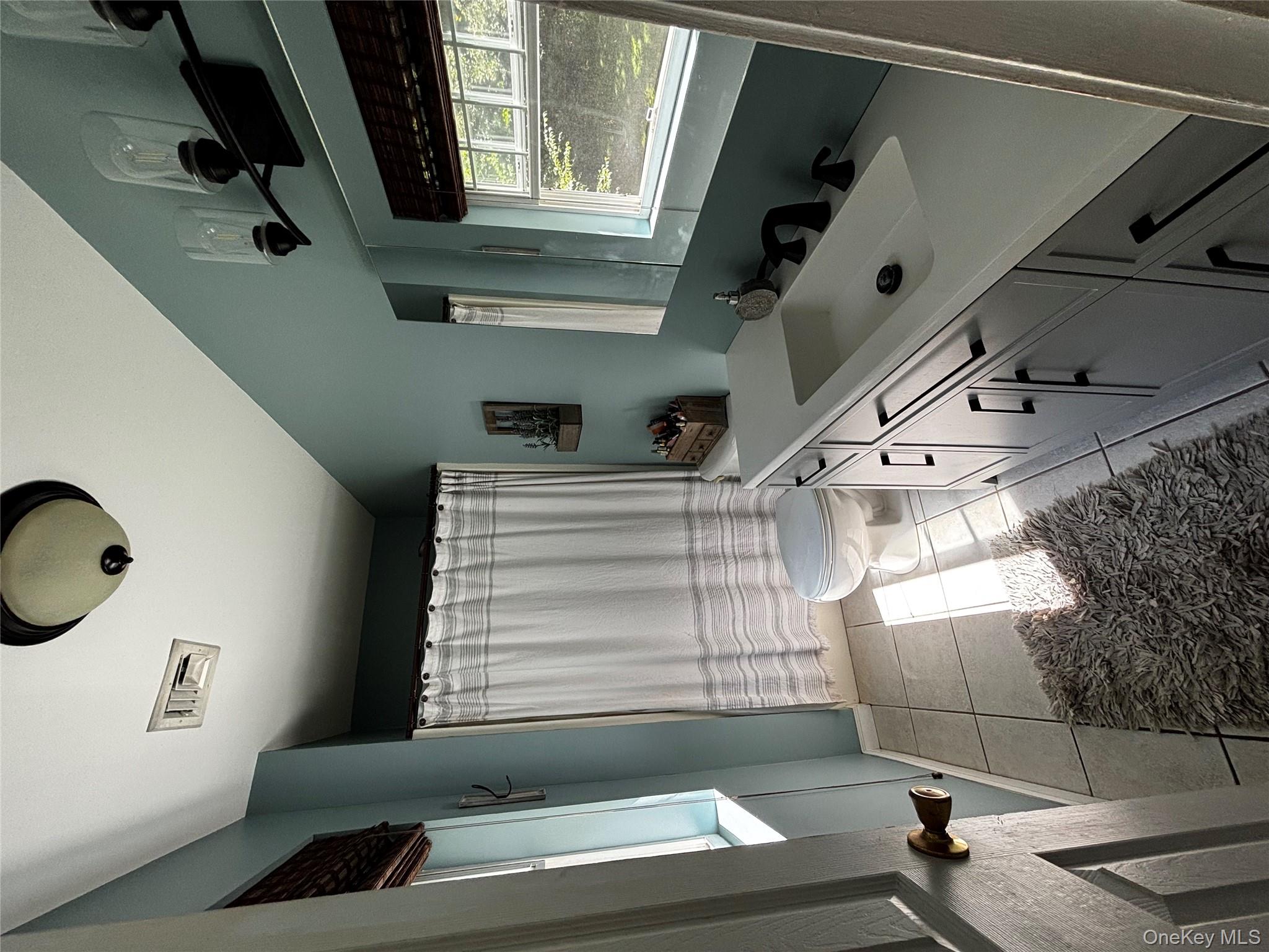 62 Triangle Of Clearwater Road Highland, NY 12528 - Photo 10 of 46 Full bathroom with vanity, light tile patterned floors, and a shower with shower curtain