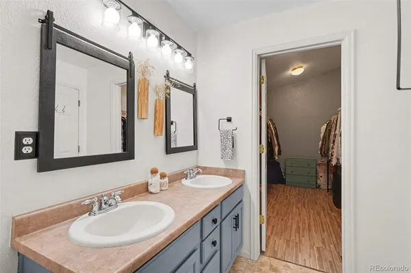 a bathroom with a sink vanity granite and a mirror