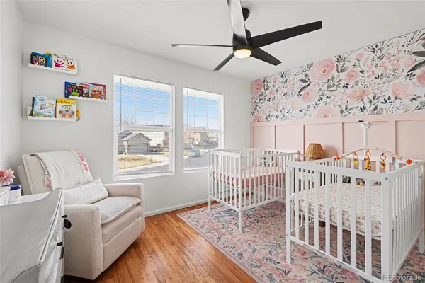 a bedroom with furniture and a large window