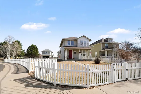 a view of a house with wooden fence