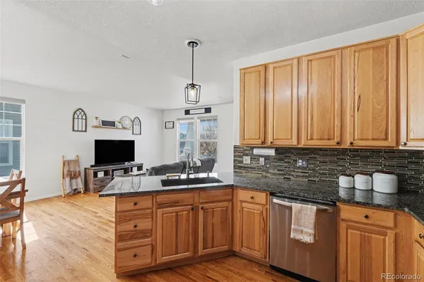a kitchen with stainless steel appliances granite countertop a sink stove and cabinets