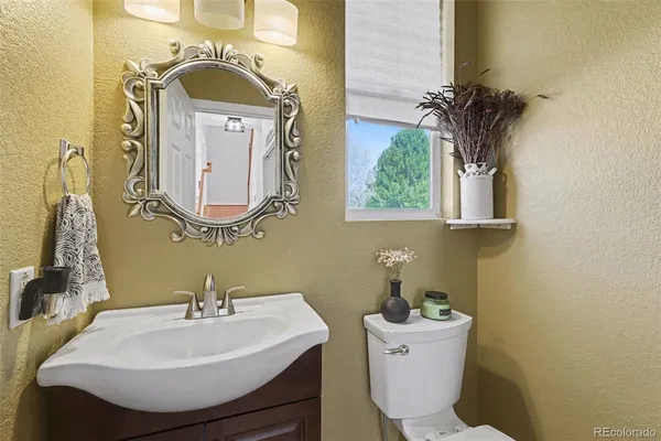a bathroom with a sink toilet and mirror