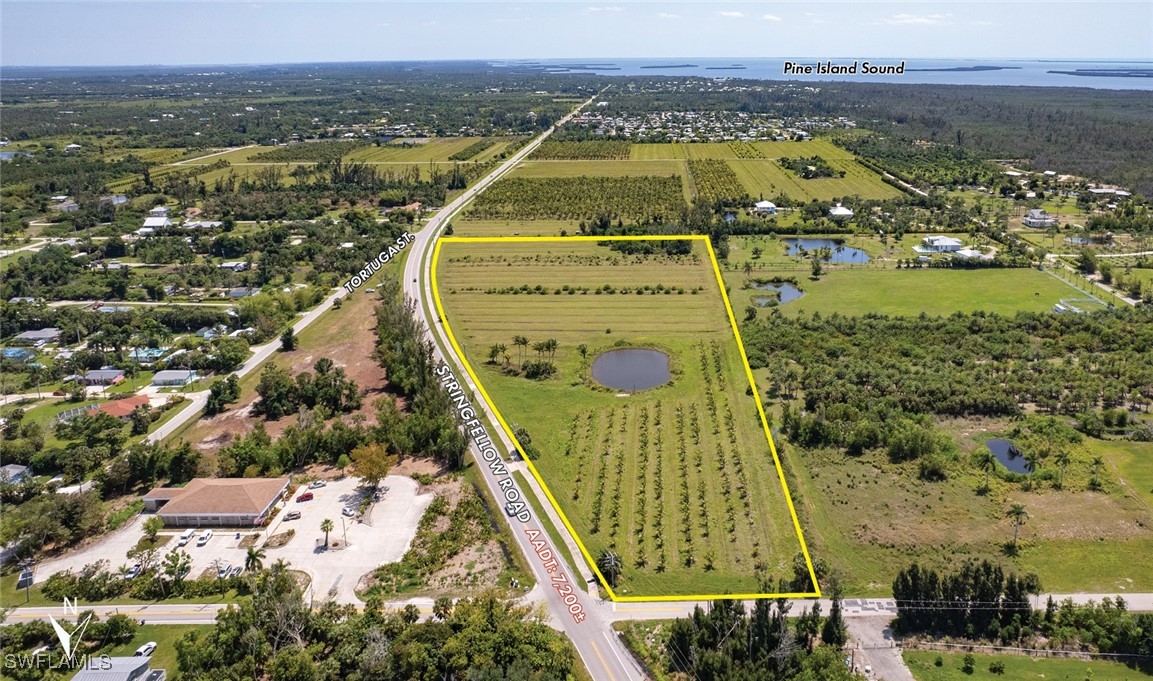 15901 Stringfellow Road Bokeelia, FL 33922 - Photo 3 of 5 an aerial view of residential houses with outdoor space