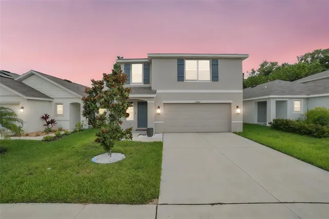 a front view of house with a garden