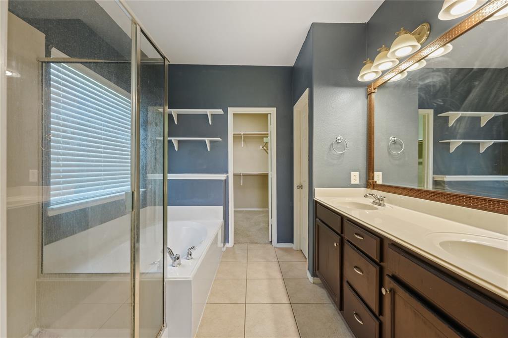 2003 Diamondback Forney, TX 75126 - Photo 16 of 30 Bathroom featuring tile flooring, large vanity, independent shower and bath, and dual sinks
