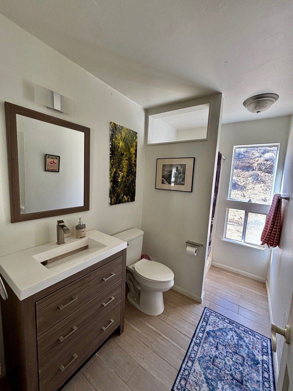 57 Bir Road Bishop, CA 93514 - Photo 13 of 35 a bathroom with a double vanity sink toilet and a mirror