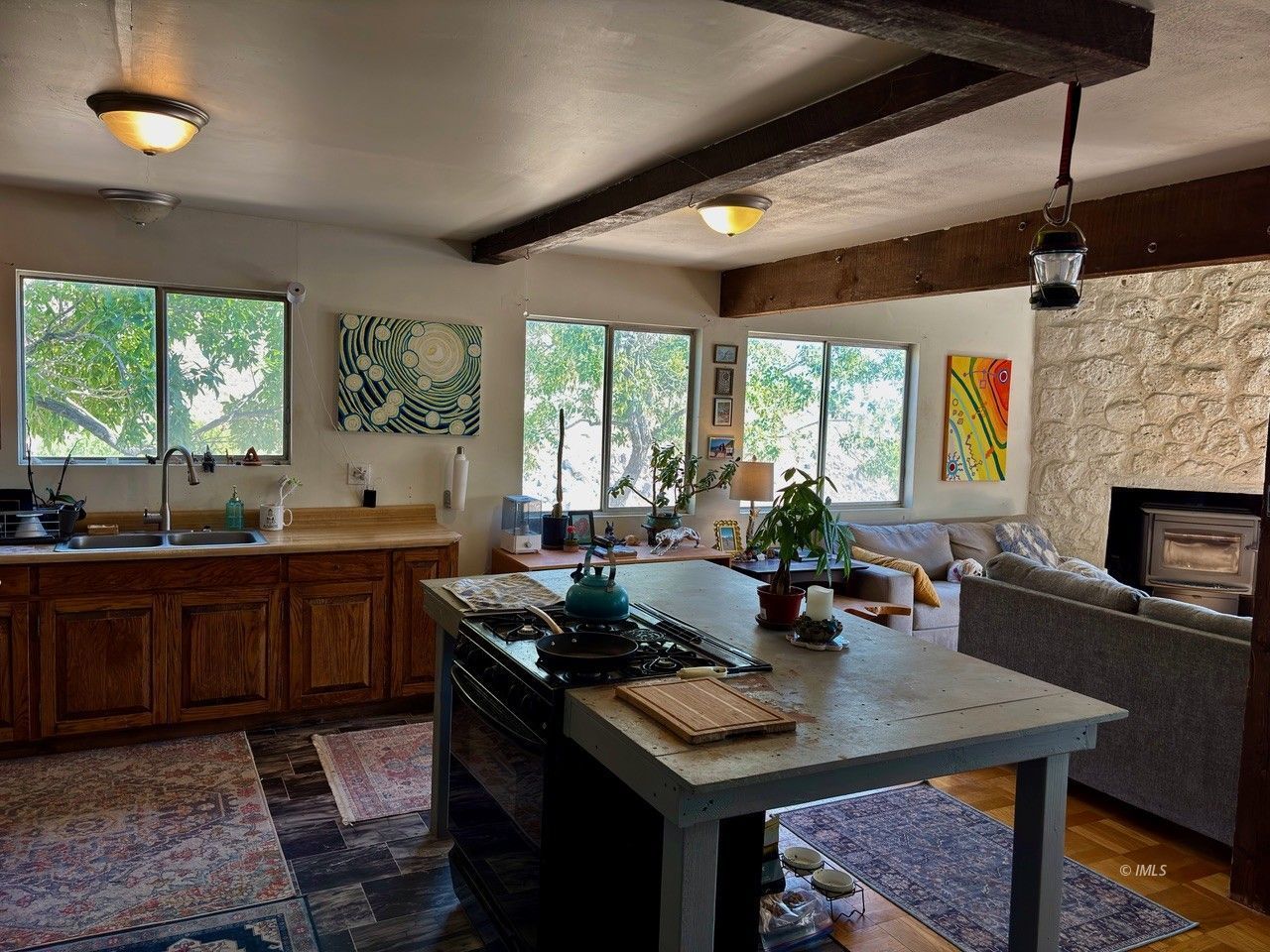 57 Bir Road Bishop, CA 93514 - Photo 5 of 35 a kitchen with a stove a sink dishwasher and a dining table with garden view