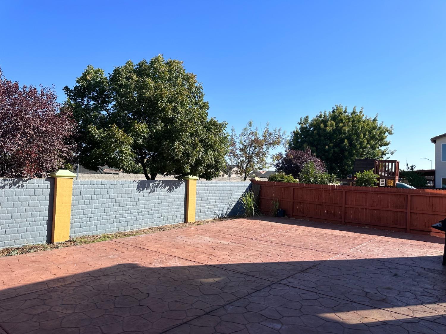 1263 Padre Street Madera, CA 93638 - Photo 13 of 26 a wooden fence with trees in the background