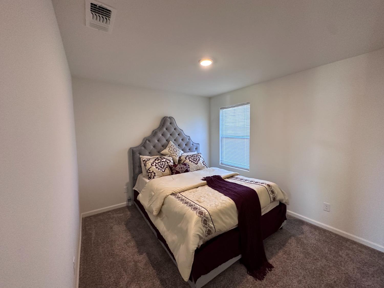 1263 Padre Street Madera, CA 93638 - Photo 20 of 26 a bedroom with a bed and a dresser