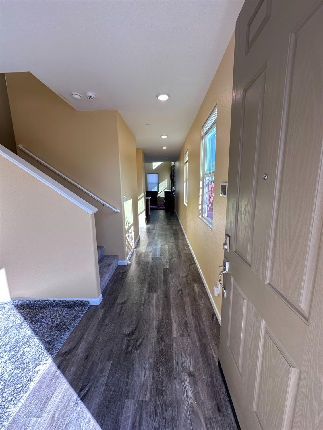 1263 Padre Street Madera, CA 93638 - Photo 2 of 26 a view of a hallway with wooden floor and stairs