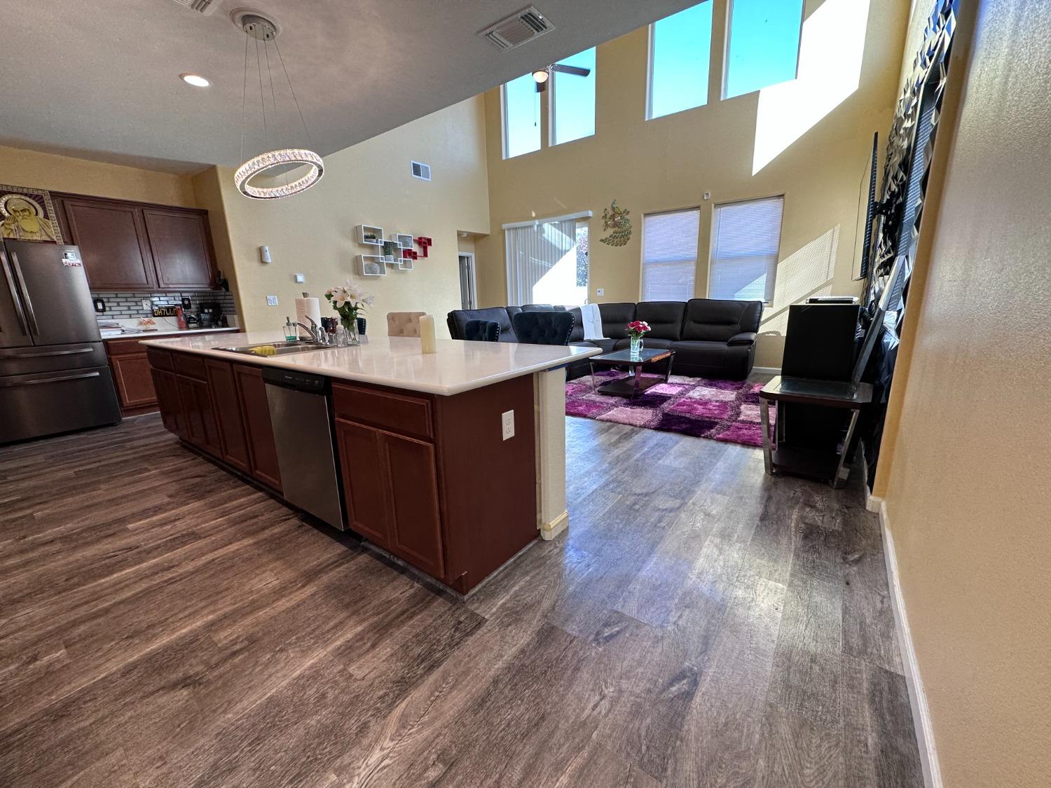 1263 Padre Street Madera, CA 93638 - Photo 5 of 26 a kitchen with wooden floors and a sink