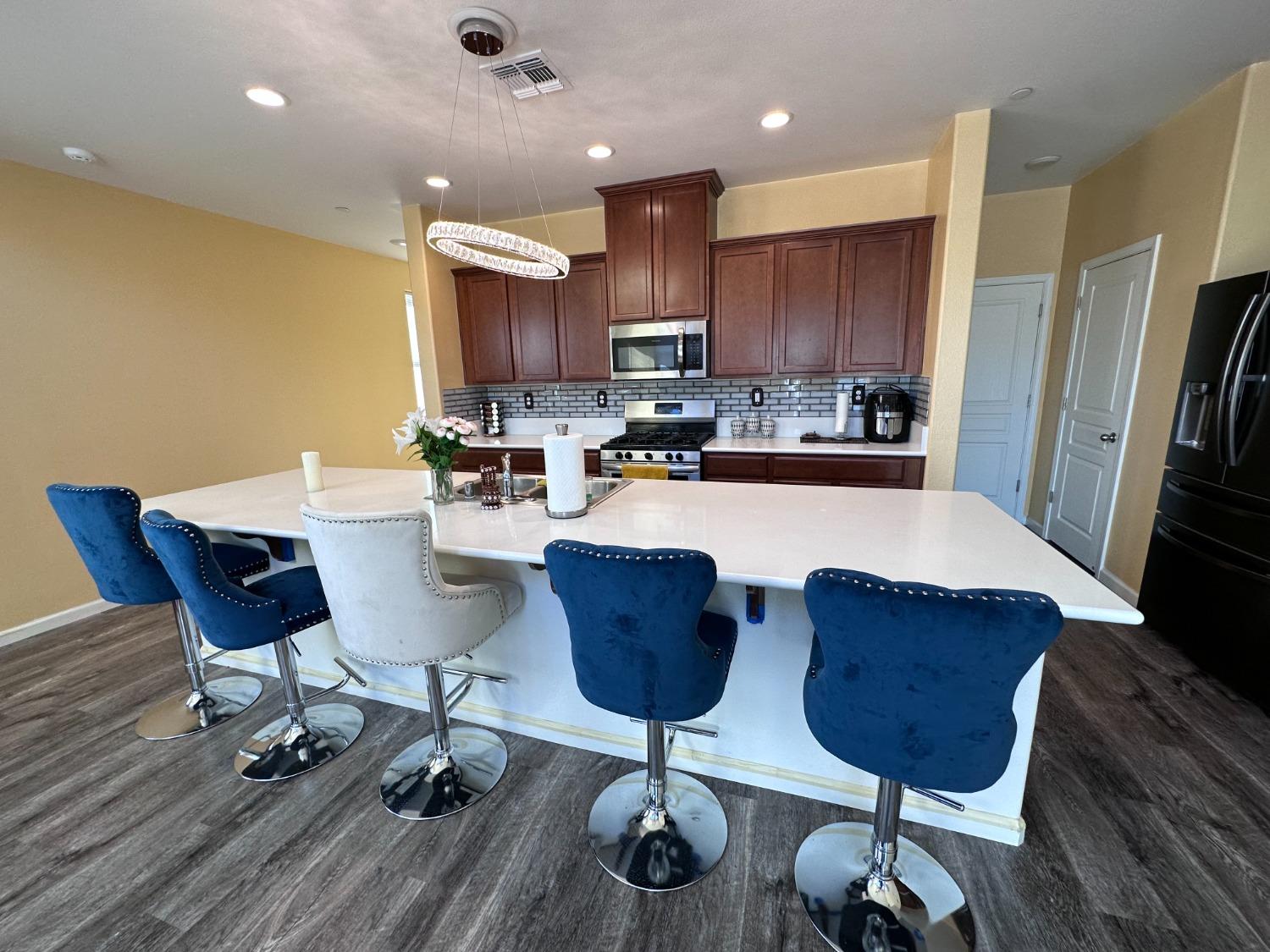1263 Padre Street Madera, CA 93638 - Photo 10 of 26 a kitchen with a dining table and chairs