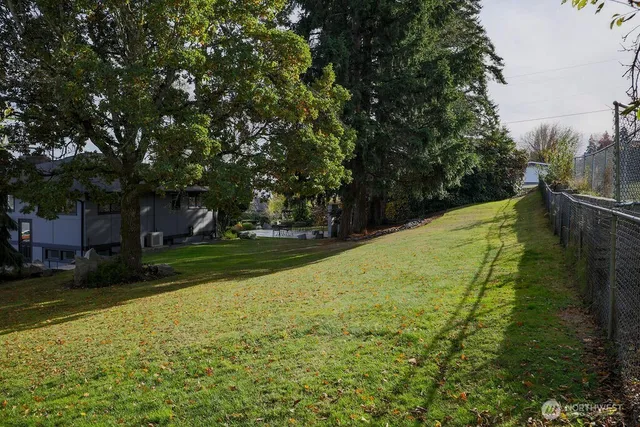 a view of a yard with swimming pool