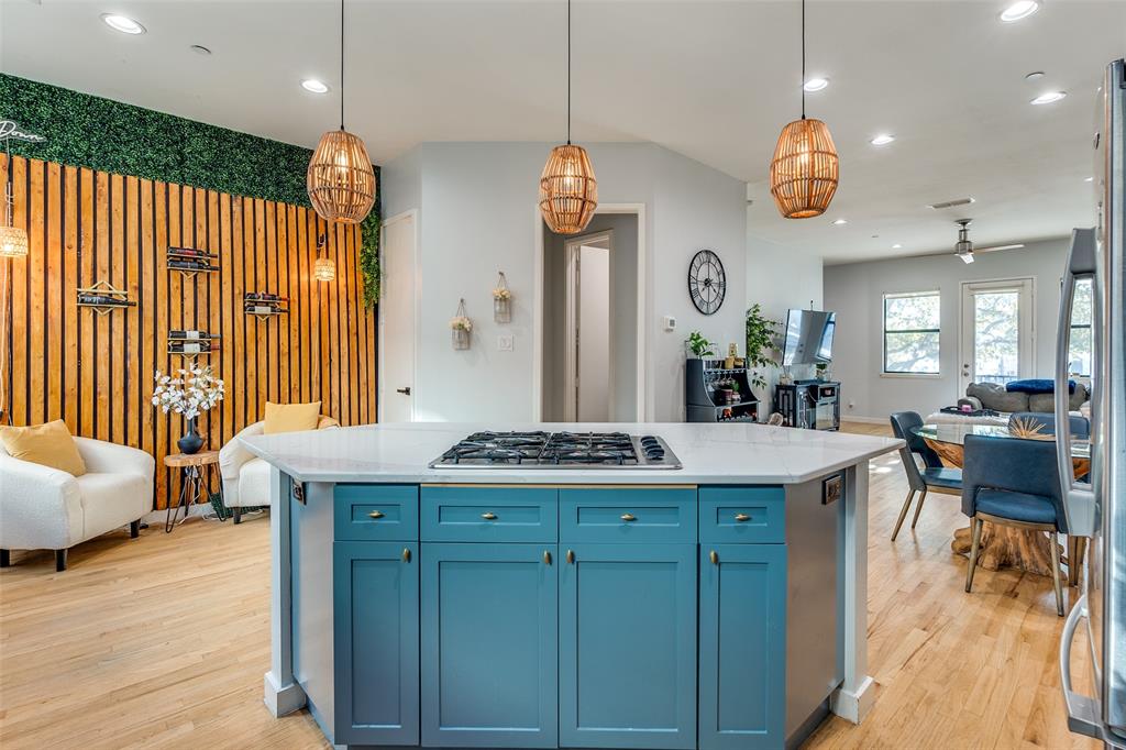 1016 Liberty Street, Unit 2 Dallas, TX 75204 - Photo 5 of 24 a view of a kitchen counter space wooden floor and a ceiling fan