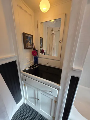 a bathroom with a sink a mirror and vanity