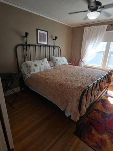 a bed sitting in a bedroom next to a window
