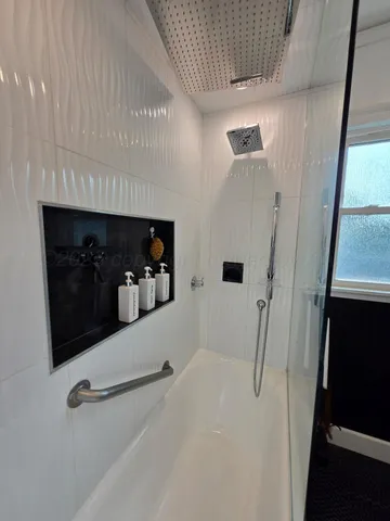 a hallway with table and staircase