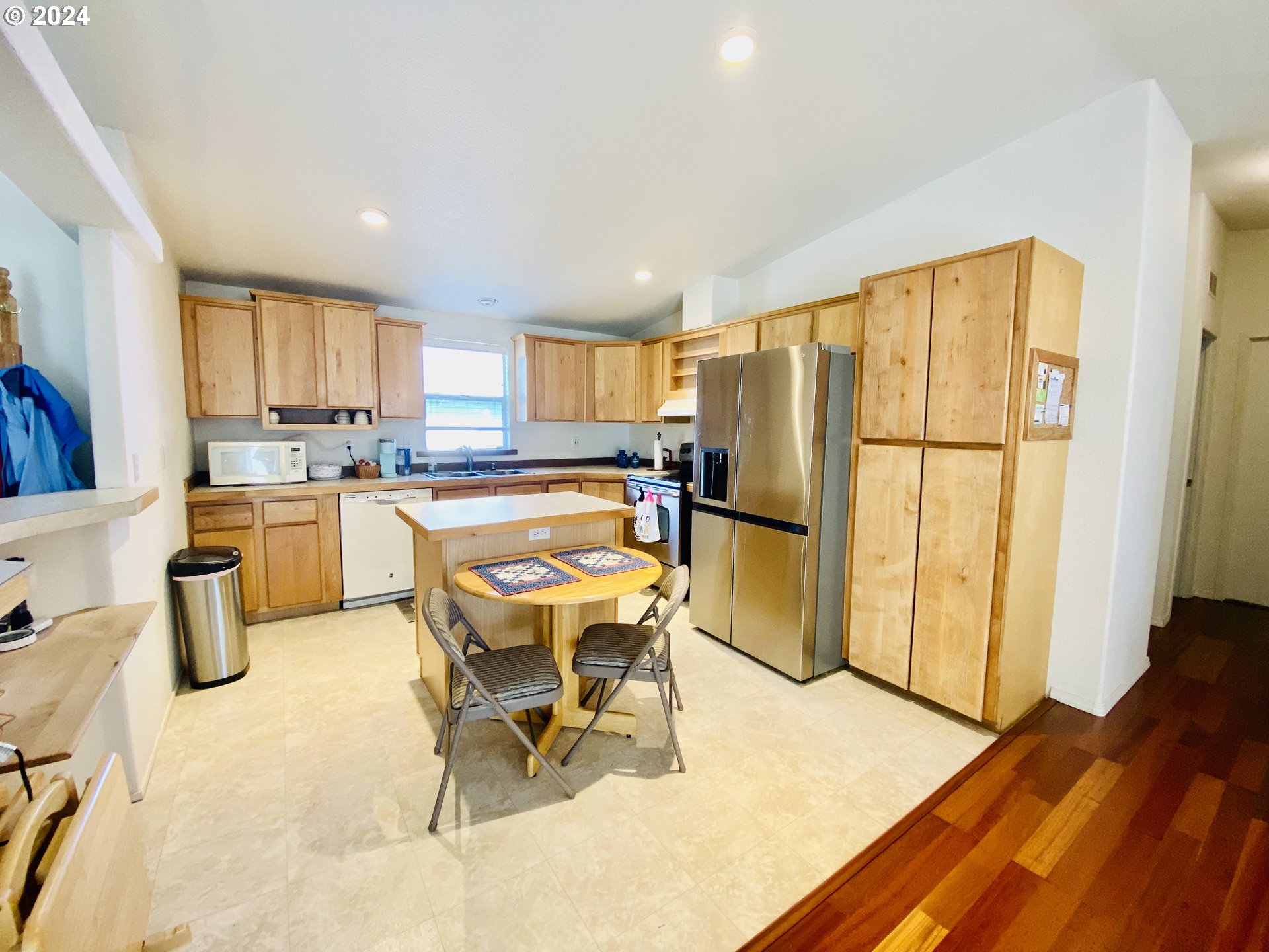 657 54th Street Springfield, OR 97478 - Photo 11 of 28 a kitchen with a sink a refrigerator and wooden cabinets