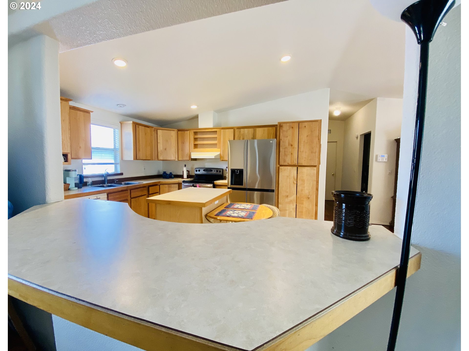 657 54th Street Springfield, OR 97478 - Photo 13 of 28 a kitchen with stainless steel appliances a refrigerator a sink a stove and cabinets