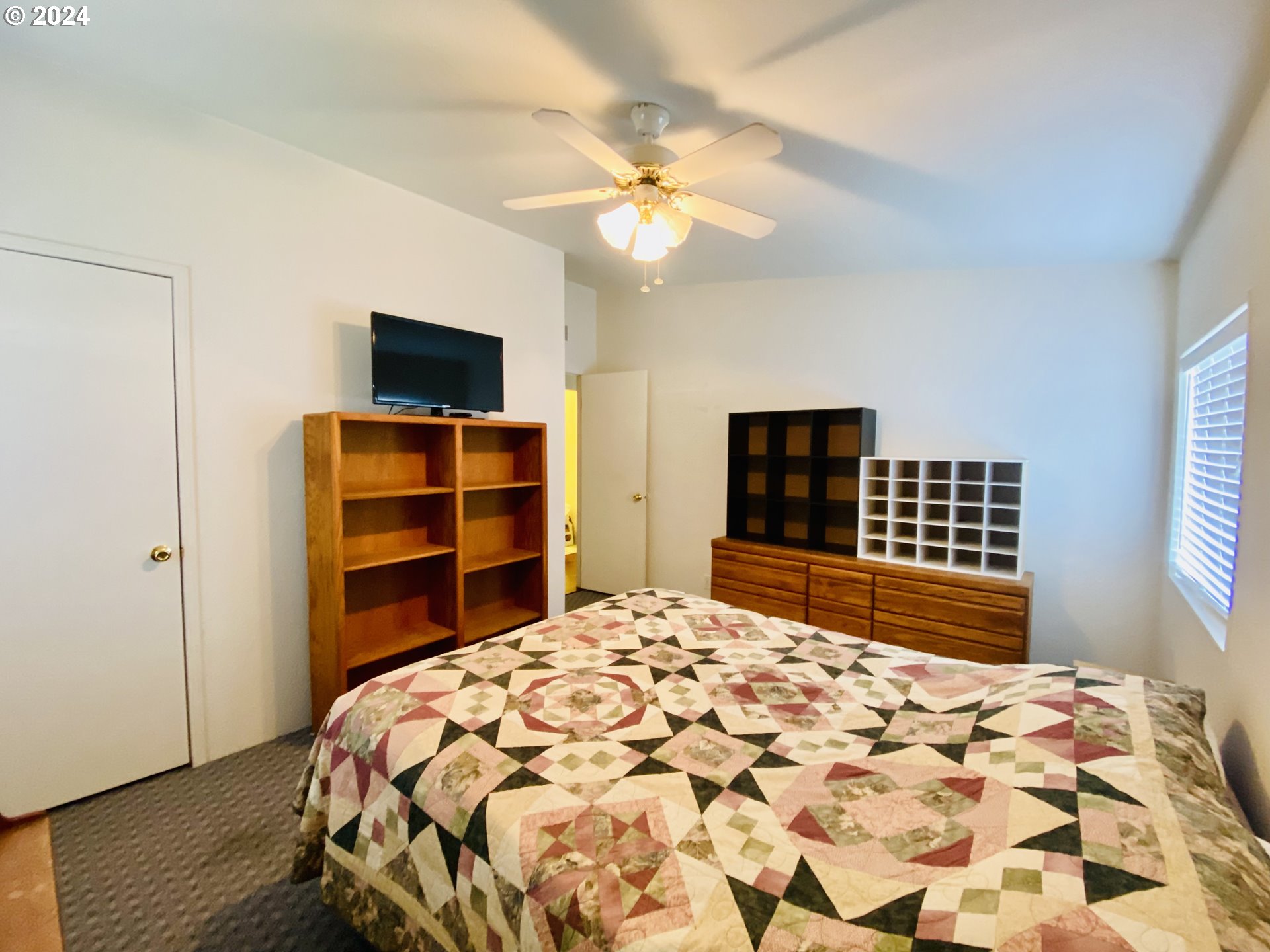 657 54th Street Springfield, OR 97478 - Photo 20 of 28 a bedroom with a bed and a flat screen tv