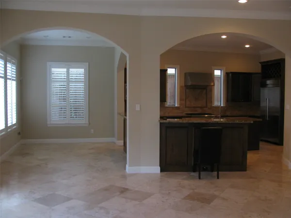 a view of kitchen with kitchen island a sink a stove and a window