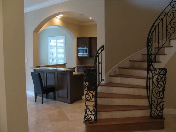 a view of entryway with wooden floor and stairs